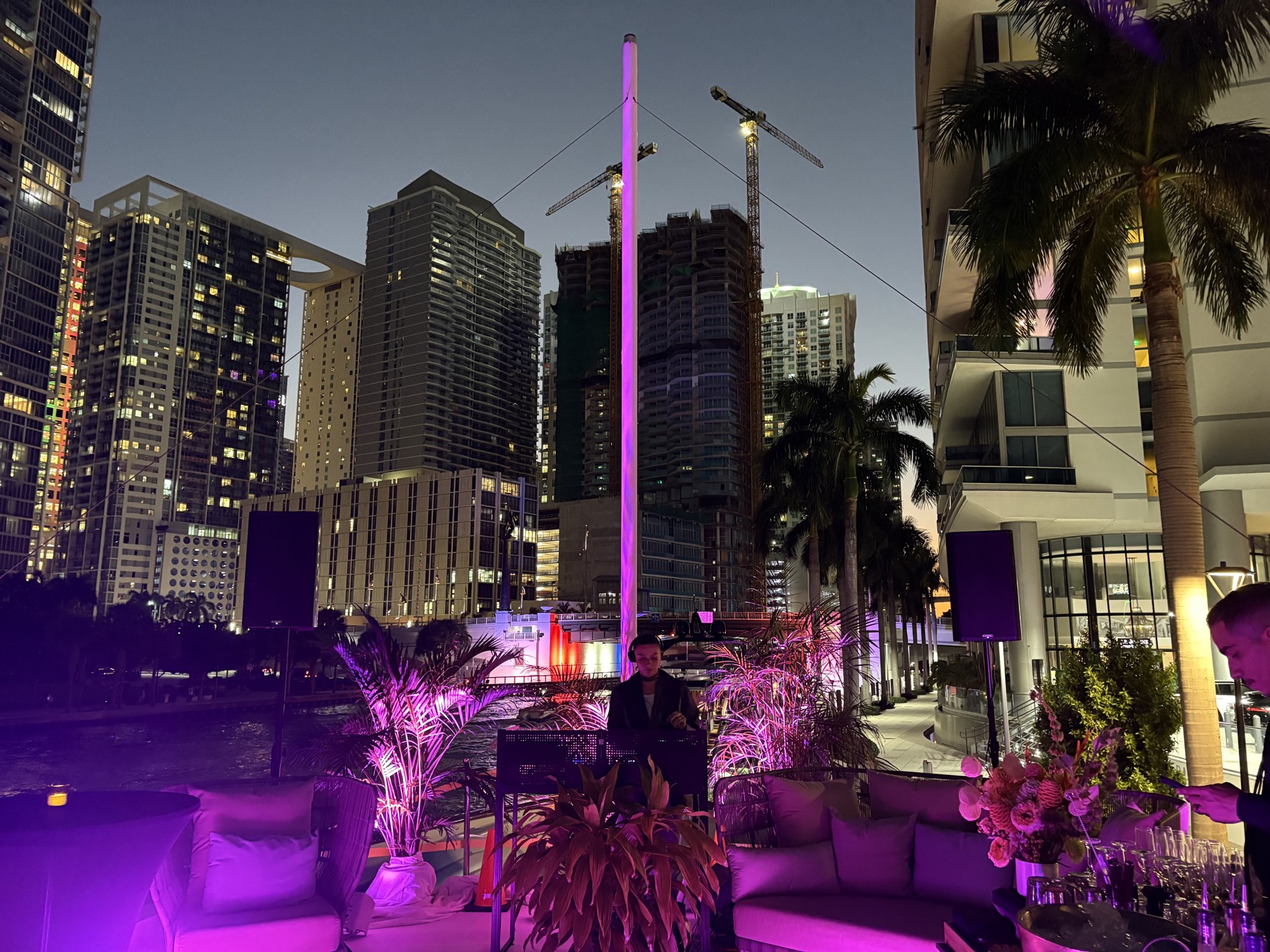 DJ set on a Miami terrace at dusk with the Brickell skyline behind