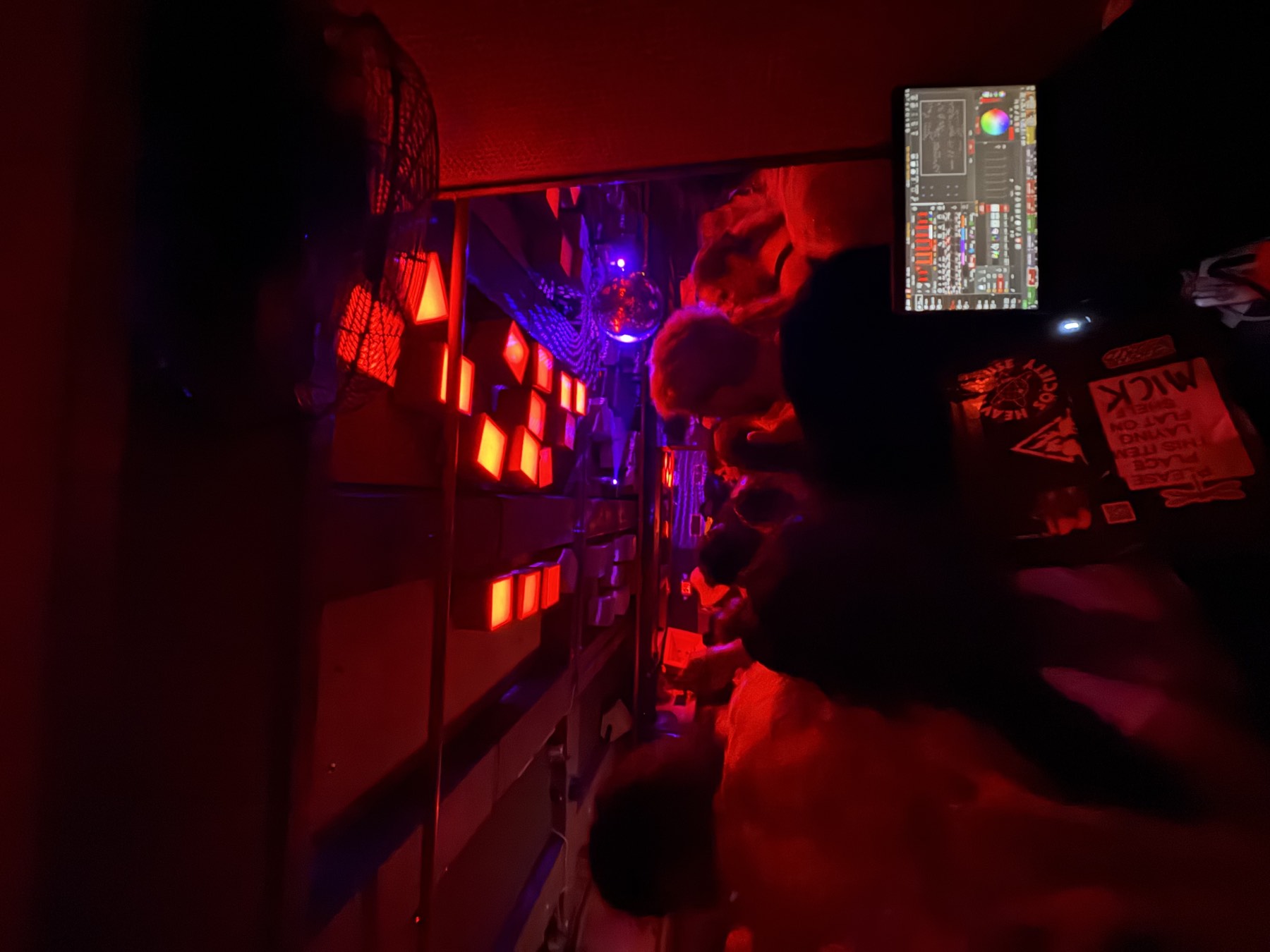 Packed South Florida club room under deep red house lighting